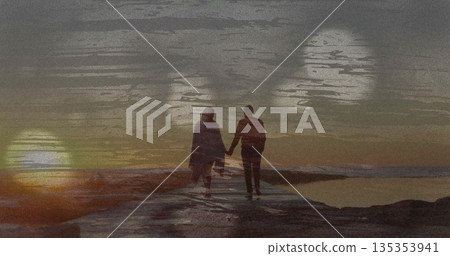 Walking couple holding hands on concrete pier into ocean at sunset, with water reflections, bokeh Walking couple holding hands on concrete pier into ocean at sunset, with water reflections, bokeh 135353941