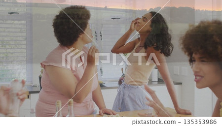 Lifting wine glasses friends sniffing aromas at kitchen island, with charcuterie board 135353986