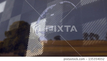 Projecting digital globe onto window pane in office, with blind shadows and tree silhouettes Projecting digital globe onto window pane in office, with blind shadows and tree silhouettes 135354032