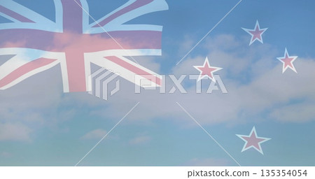 Floating New Zealand flag over blue sky with clouds, with Union Jack emblem and red stars Floating New Zealand flag over blue sky with clouds, with Union Jack emblem and red stars 135354054