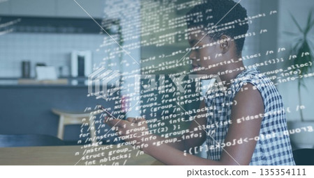 Woman in checked blouse using smartphone viewing code at kitchen table with coffeemaker, copy space 135354111