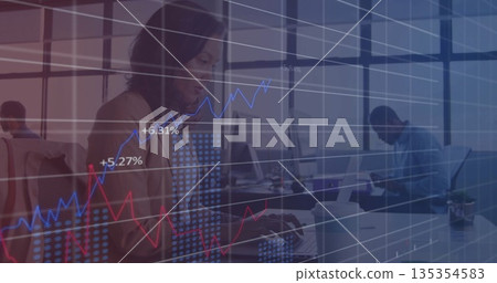 Typing woman wearing blazer working on laptop in open-plan office, with financial graphs overlay Typing woman wearing blazer working on laptop in open-plan office, with financial graphs overlay 135354583