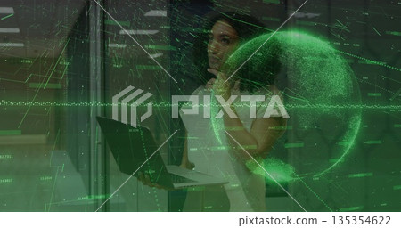 Analyzing woman in office attire interacting with holographic display in lab, with laptop and globe 135354622