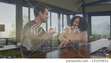Sipping coffee couple sharing relaxed conversation at modern kitchen island, with ceramic mugs Sipping coffee couple sharing relaxed conversation at modern kitchen island, with ceramic mugs 135354652