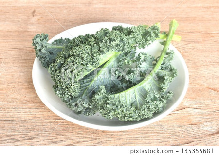fresh green Curly Kale vegetable salad with drop of water arranging on plate fresh green Curly Kale vegetable salad with drop of water arranging on plate 135355681