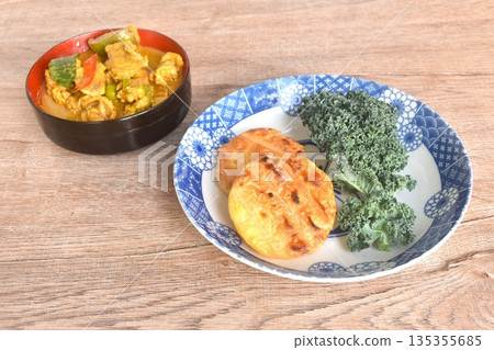 spicy boiled slice pork eggplant in curry soup eat couple grilled sticky rice with egg and curly kale vegetable on plate spicy boiled slice pork eggplant in curry soup eat couple grilled sticky rice with egg and curly kale vegetable on plate 135355685