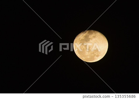 bright yellow full moon spreading light floating on sky in night background 135355686