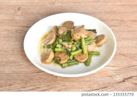 spicy stir fried beef meatball couple slice yard long bean with basil on plate spicy stir fried beef meatball couple slice yard long bean with basil on plate 135355770