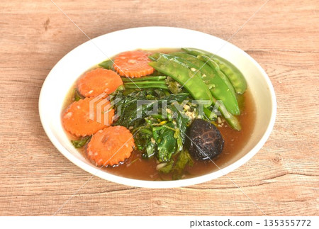 fried mixed vegetable dressing sesame oil and soy sauce with chop garlic on plate 135355772