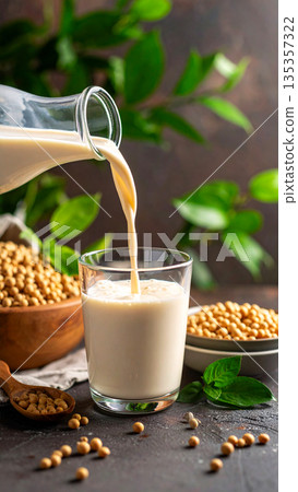 Plant based milk captured mid-pour into a glass, showcasing motion freeze and clean beverage style 135357322