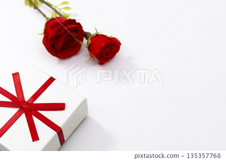 Red roses and gift box on white background Red roses and gift box on white background 135357768