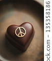 Luxury heart-shaped chocolate with a gold peace sign and copy space 135358186