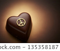 Luxury heart-shaped chocolate with a gold peace sign and copy space 135358187