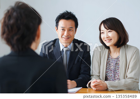 A Japanese couple consulting about finding a partner at a marriage consultation office. Counseling session aimed at finding a successful marriage A Japanese couple consulting about finding a partner at a marriage consultation office. Counseling session aimed at finding a successful marriage 135358489