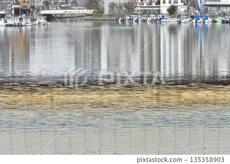 A pleasure boat parked at the mouth of the Ebi River, with the Keiyo Road reflected in the water A pleasure boat parked at the mouth of the Ebi River, with the Keiyo Road reflected in the water 135358903