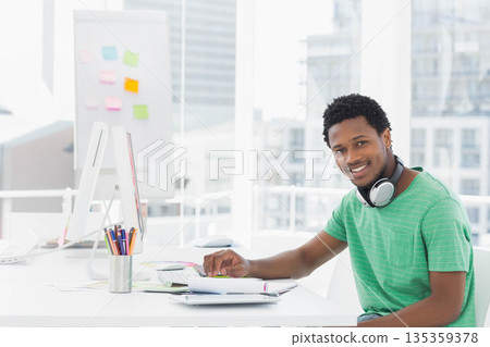 African American man working on design with computer and color wheel in design studio, copy space 135359378