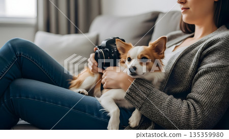 Comfortable and Relaxed Person Sitting on a Sofa with Their Pet Sharing Warm Moments of Affection and Calm 135359980