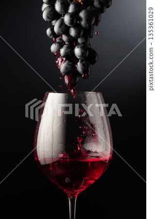 Red wine flows down the grape cluster into the glass. Red wine flows down the grape cluster into the glass. 135361029
