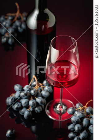 Red wine and juicy blue grapes. Red wine and juicy blue grapes. 135361033
