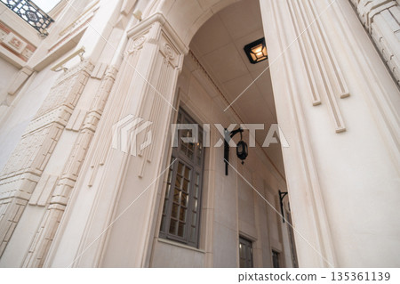 Entrance, Ornate, Building: Closeup View of an Ornate Building Entrance with a Window and a Lantern Entrance, Ornate, Building: Closeup View of an Ornate Building Entrance with a Window and a Lantern 135361139