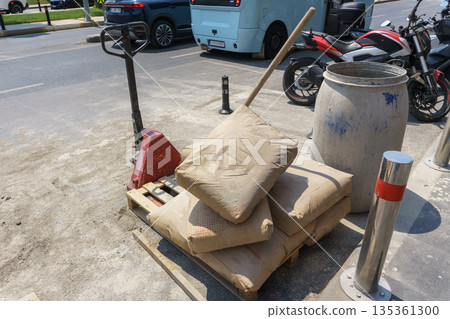 Repair work on roads with bags of cement on a pallet. 135361300