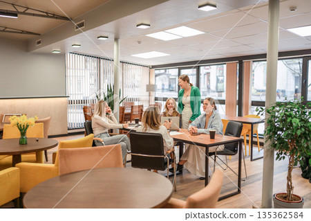 Business collaboration meeting of four women discussing strategy in a bright modern office. Business collaboration meeting of four women discussing strategy in a bright modern office. 135362584