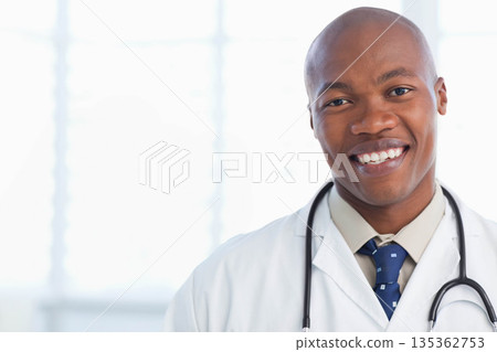 African American male doctor wearing lab coat, holding stethoscope by clinic windows, copy space African American male doctor wearing lab coat, holding stethoscope by clinic windows, copy space 135362753