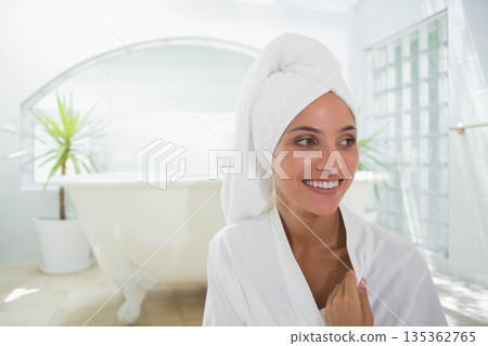 Woman standing near clawfoot bathtub in bathroom wearing bathrobe and towel turban, copy space Woman standing near clawfoot bathtub in bathroom wearing bathrobe and towel turban, copy space 135362765