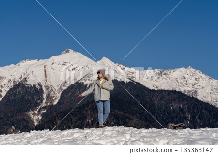 Mountains Woman Winter: Snowcapped Alps, solo female hiker enjoying scenic view, sunny day. 135363147