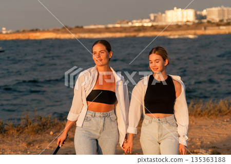 Women Sunset Beach Walk Couple Holding Hands Casual Clothing 135363188