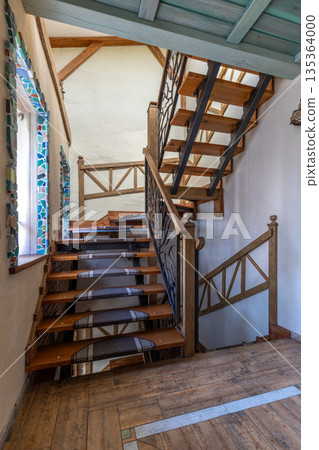Rustic Wooden Staircase with Wrought Iron Railing and Natural Light Rustic Wooden Staircase with Wrought Iron Railing and Natural Light 135364000