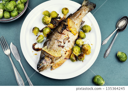 Whole trout fish baked in an oven. Whole trout fish baked in an oven. 135364245