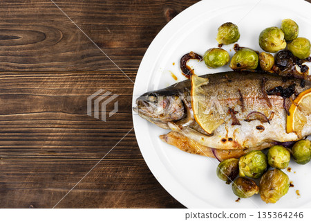 Fried trout with Brussels sprouts. Fried trout with Brussels sprouts. 135364246