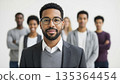 Professional African American businessman with glasses leading diverse team in modern office workplace environment 135364454