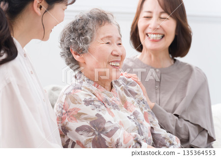 Smiling female three generation family 135364553