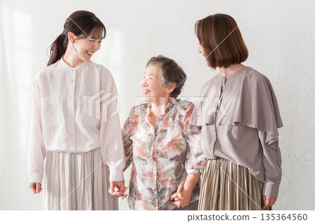 Smiling female three generation family 135364560
