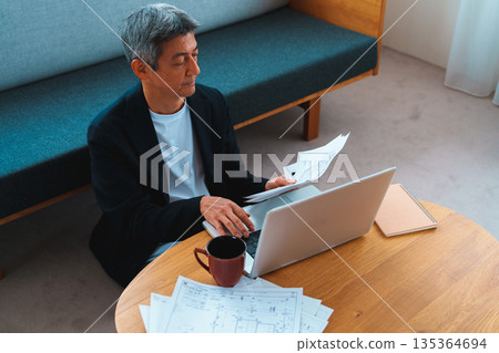 A man working on a computer A man working on a computer 135364694