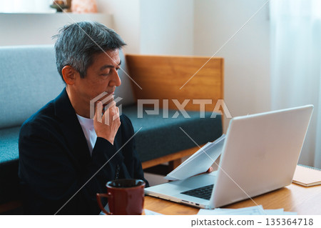 A man working on a computer 135364718