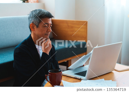 A man working on a computer 135364719