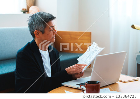 A man working on a computer 135364725