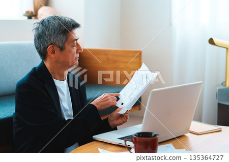 A man working on a computer A man working on a computer 135364727