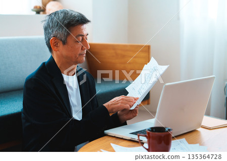 A man working on a computer A man working on a computer 135364728