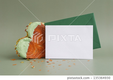 White empty mock up template paper note card Delicious fresh croissant topped with Matcha Green Tea flavor Ganache. Creation unique heart shape bakery. Puff pastry holiday love gift present idea 135364930