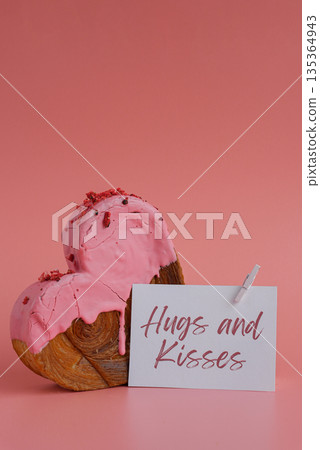 HUGS AND KISSES holiday card paper note Heart shaped strawberry berry croissant on pink background with copy space. Puff pastry new trendy sweet dessert bakery. Creamy dough 135364943