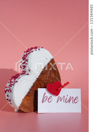 Valentin day BE MINE wishes saying caption on greeting card Delightful heartshaped pastry croissant treat, beautifully topped with colorful frosting galore. Copy space. Food experimentation viral 135364985