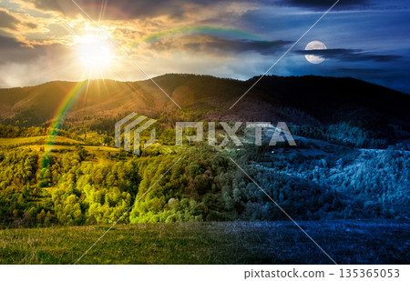forested mountain slopes in spring. time change concept. lovely countryside landscape with sun and moon. mountainous rural area under the cloudy sky. uncertainty, trust issues, difficult relationship 135365053