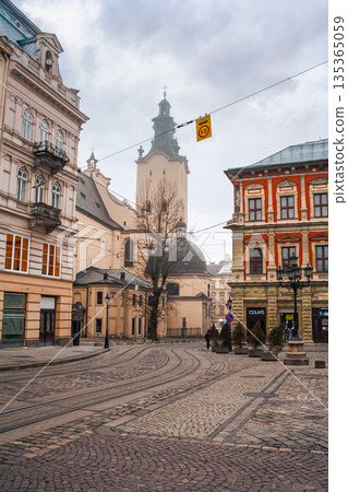 lviv, ukraine - 17 nov 2012: view of lviv city architecture on a misty morning. concept scene of old town with cobblestone street. background for travel urban europe in autumn 135365059