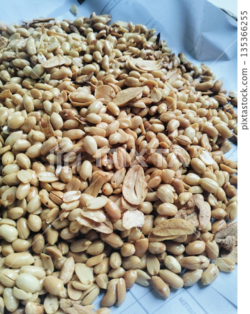 Roasted peanuts mixed with garlic as a traditional savory snack with crunchy texture and natural food background 135366255