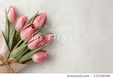 Bouquets of pink tulips arranged with care on a light surface near the end of winter Bouquets of pink tulips arranged with care on a light surface near the end of winter 135366996