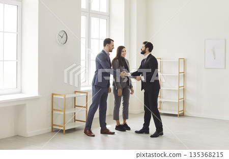 Handshake between realtor and client during property viewing, meeting to sign contract Handshake between realtor and client during property viewing, meeting to sign contract 135368215